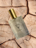 Perfume bottle labeled 'Earth' on a textured beige background